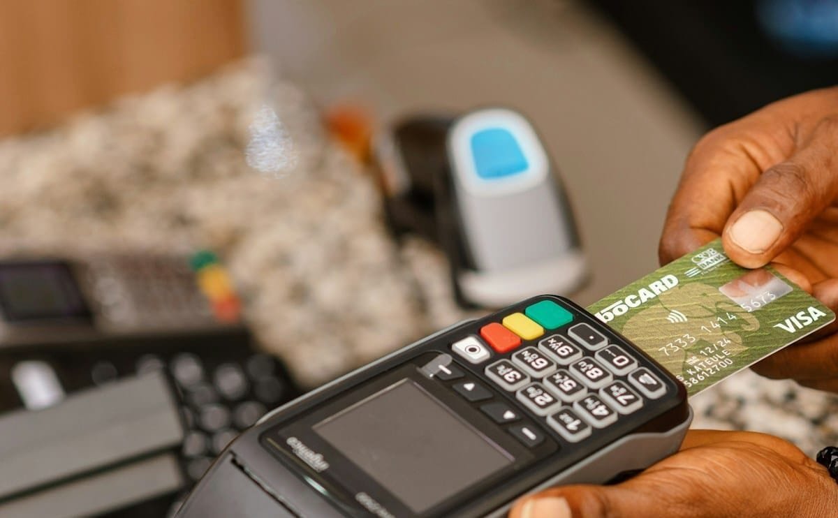 a person holding a credit card in their hand